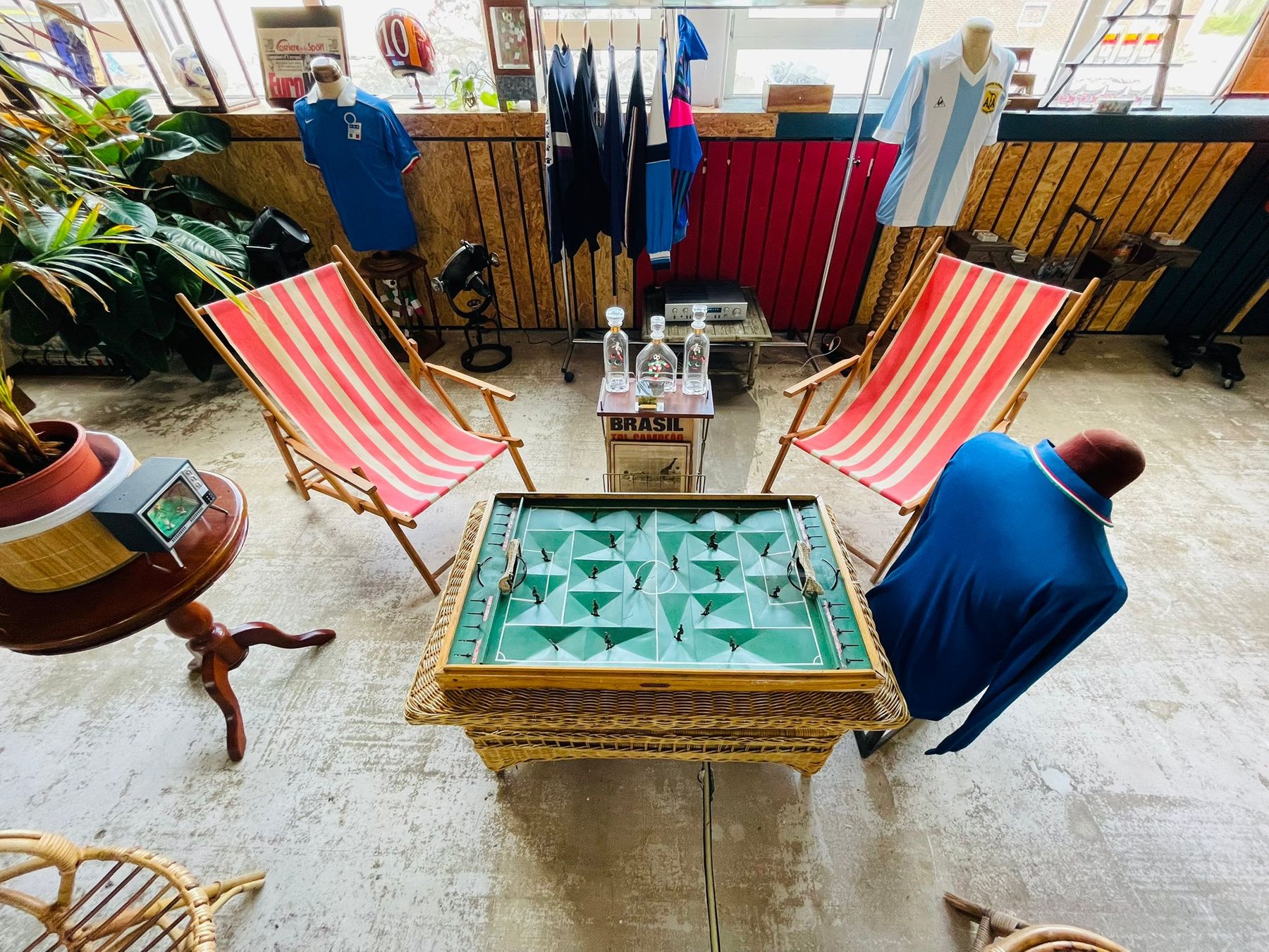 Deckchairs, Subbuteo table and vintage shirts arranged inside the studio