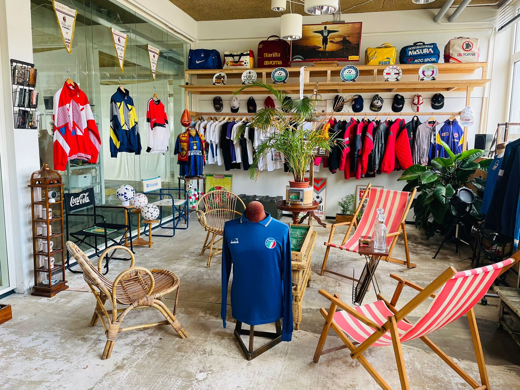 Wide view of the Calcio90 Studios showroom with vintage shirts, bags, pennants and furniture